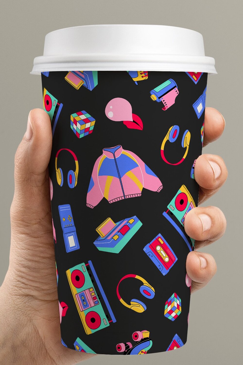 Person holding a cup with a pattern on it.