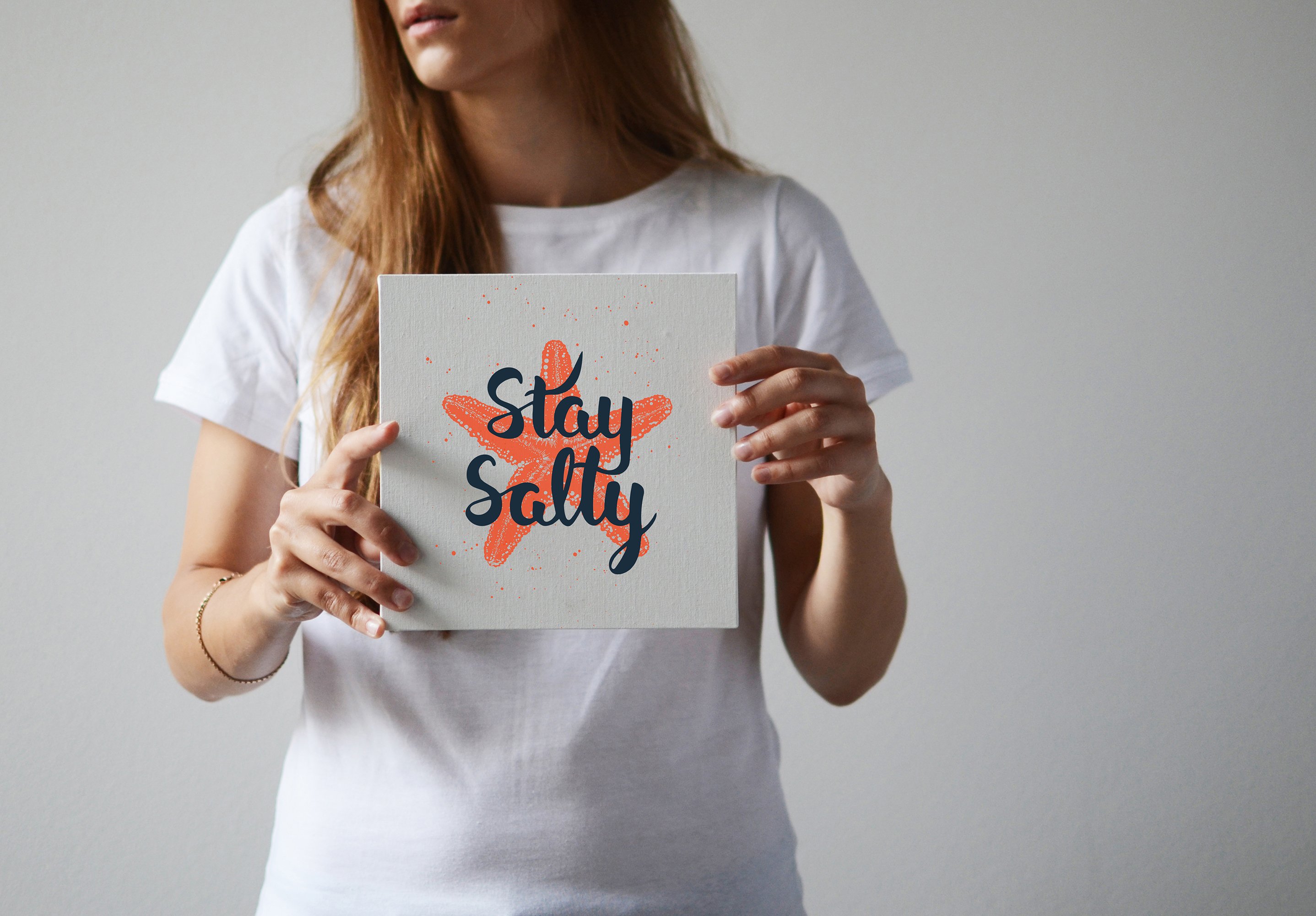 Woman holding a sign that says stay salty.