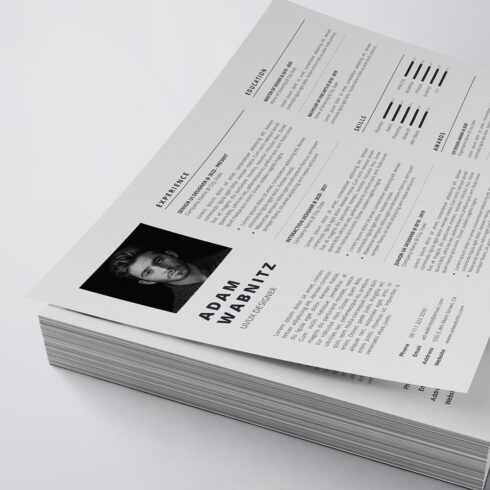 Stack of white paper with a black and white photo on it.