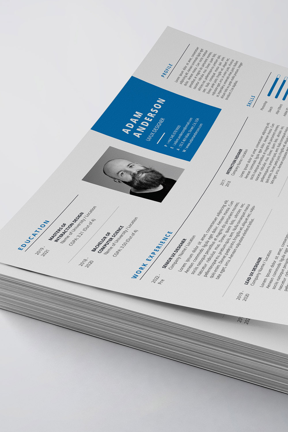 White and blue resume on top of a stack of papers.