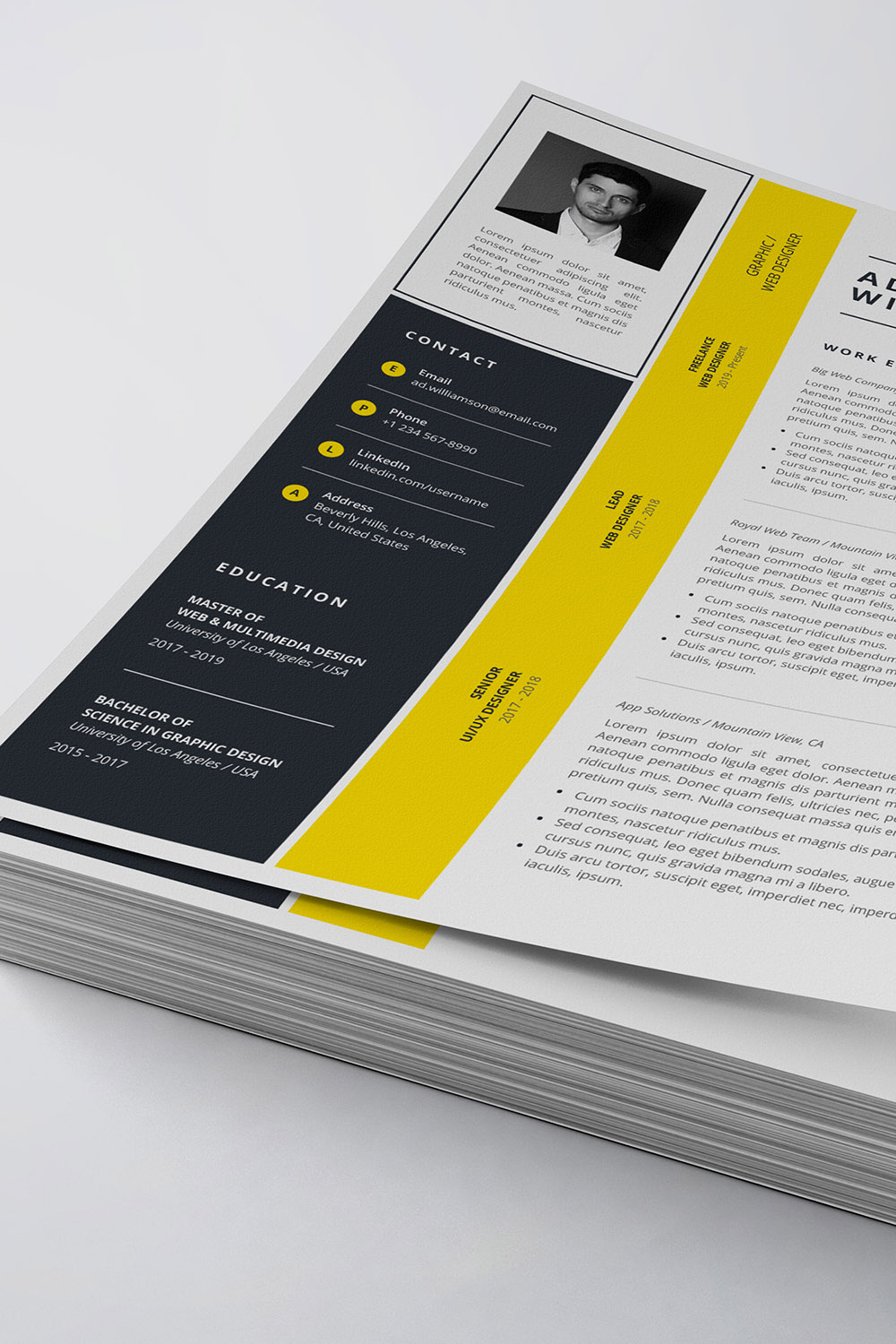 Yellow and black resume on top of a stack of papers.