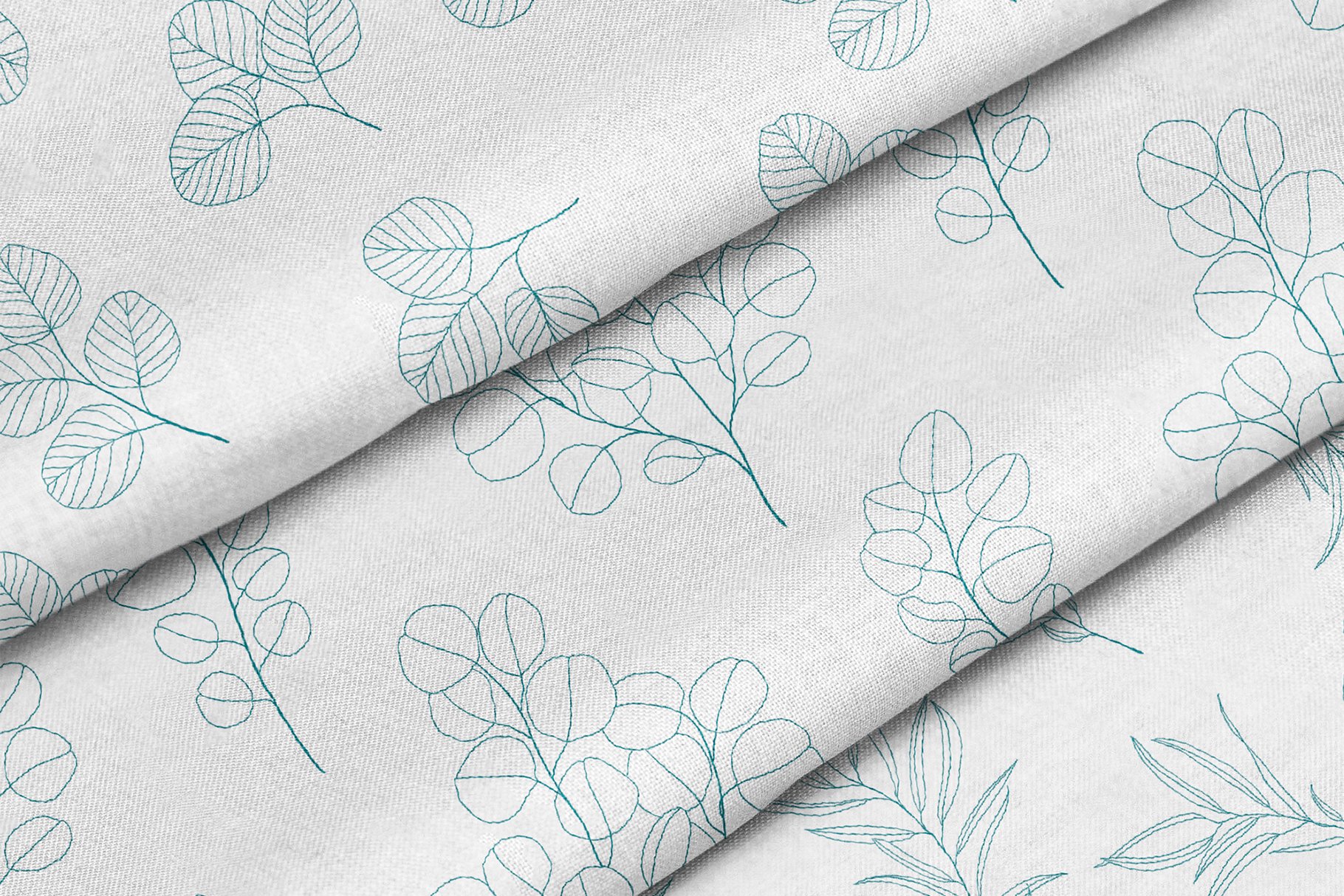White fabric with blue leaves on it.