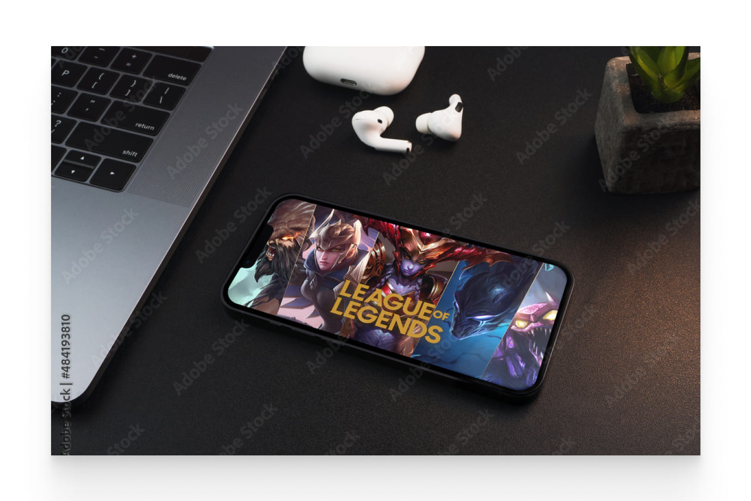 League of Legends game app on the smartphone screen on black background table.