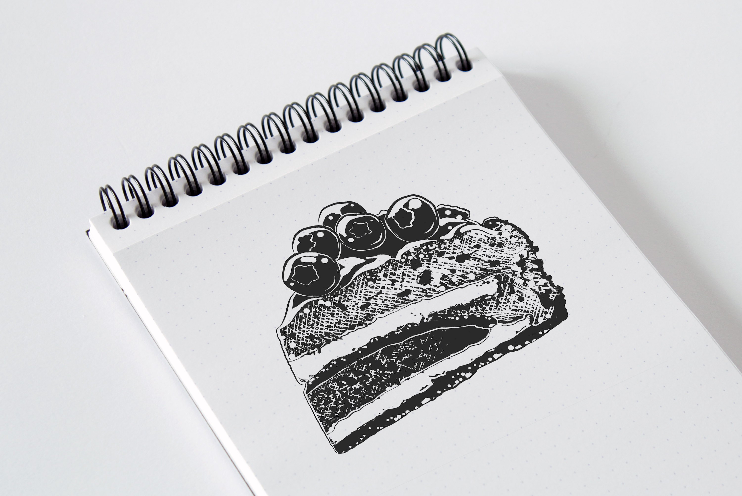 A notebook with a drawing of a piece of cake.