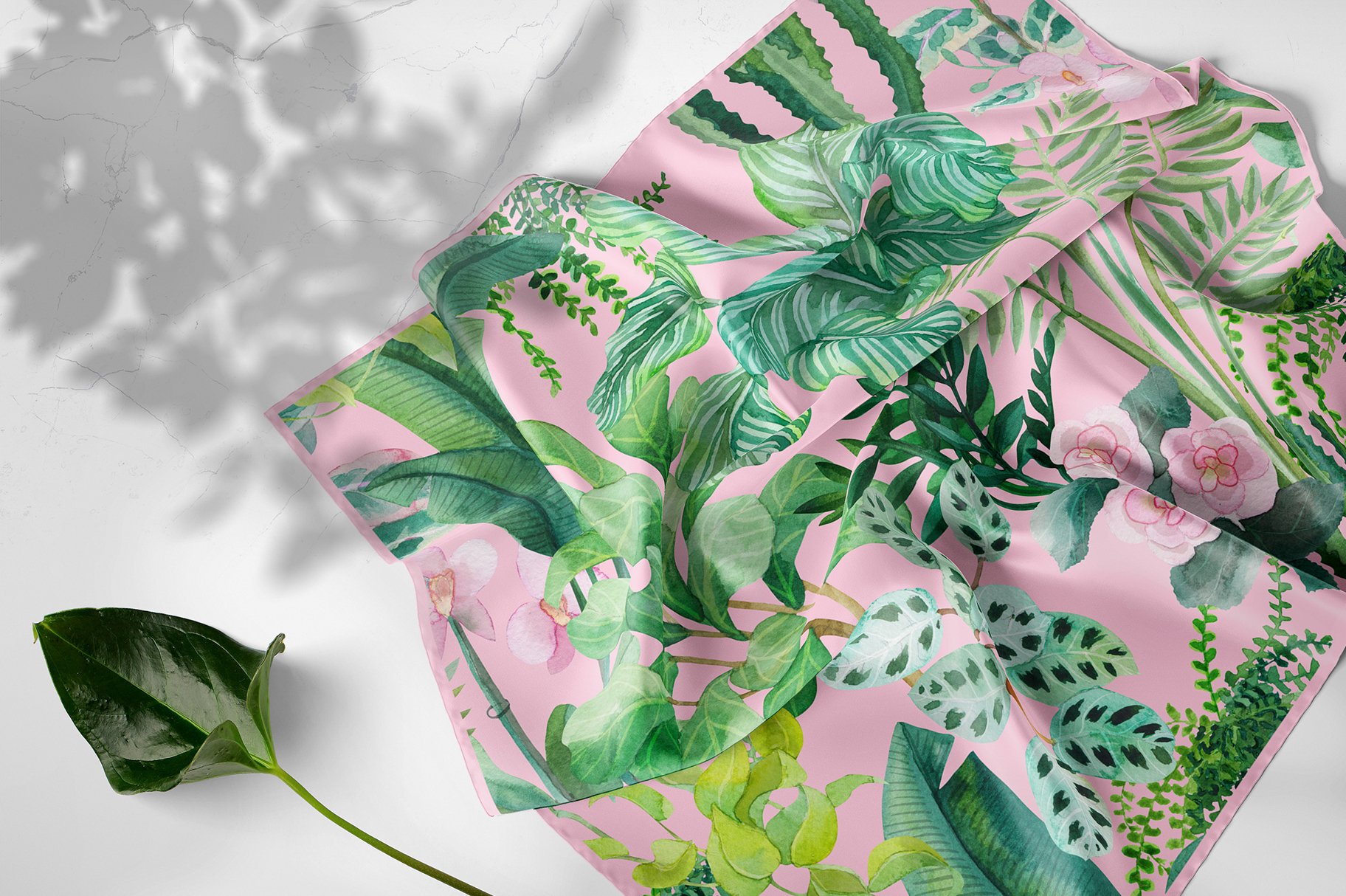 Pink scarf with green leaves and pink flowers.