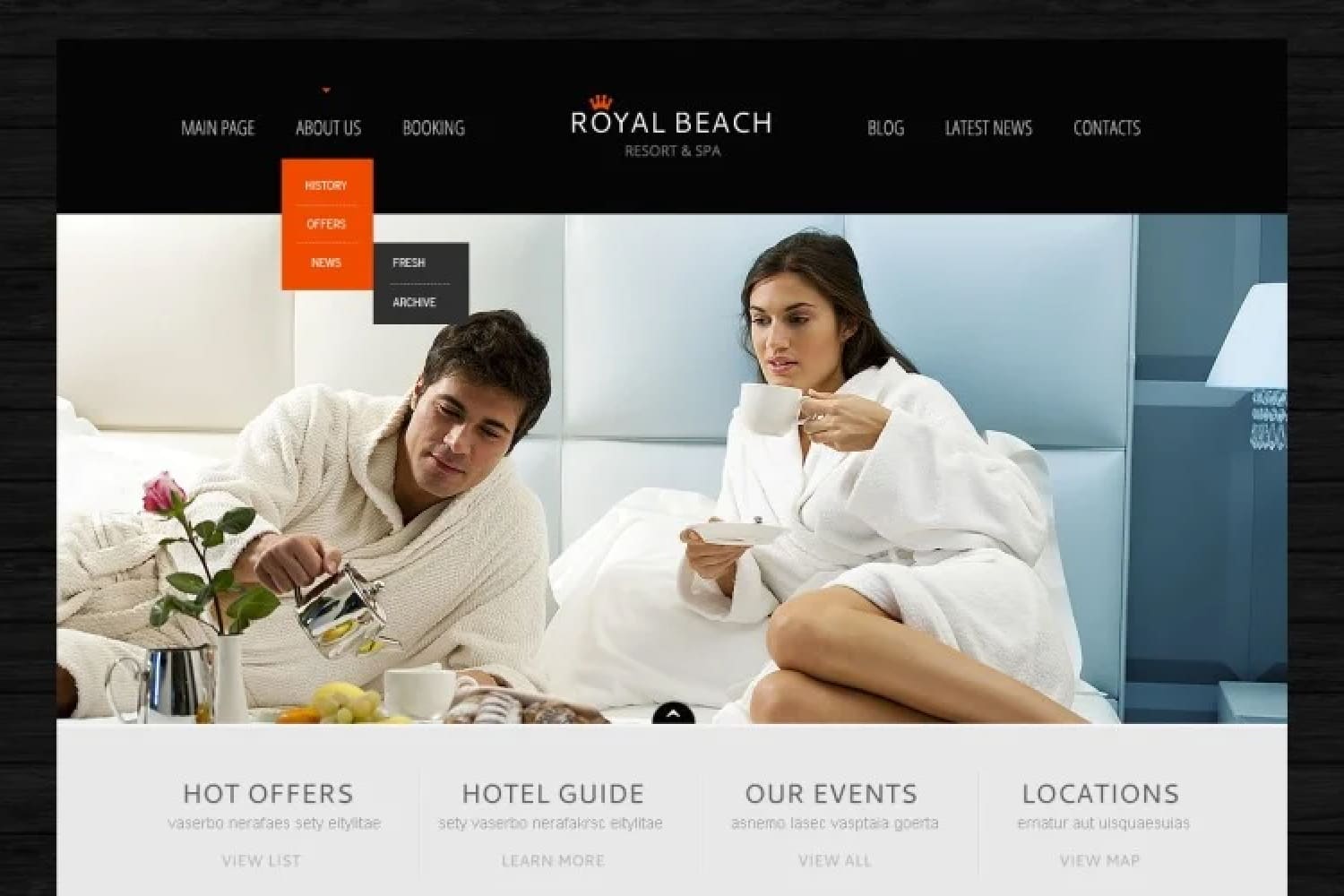 Hotel website home page with photo of couple in bathrobes on bed in room.