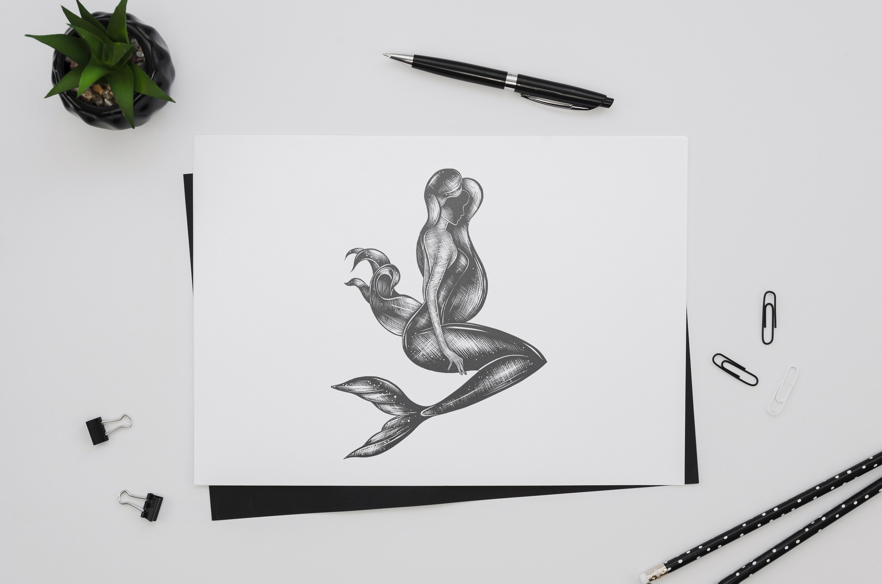 Black and white drawing of a mermaid.