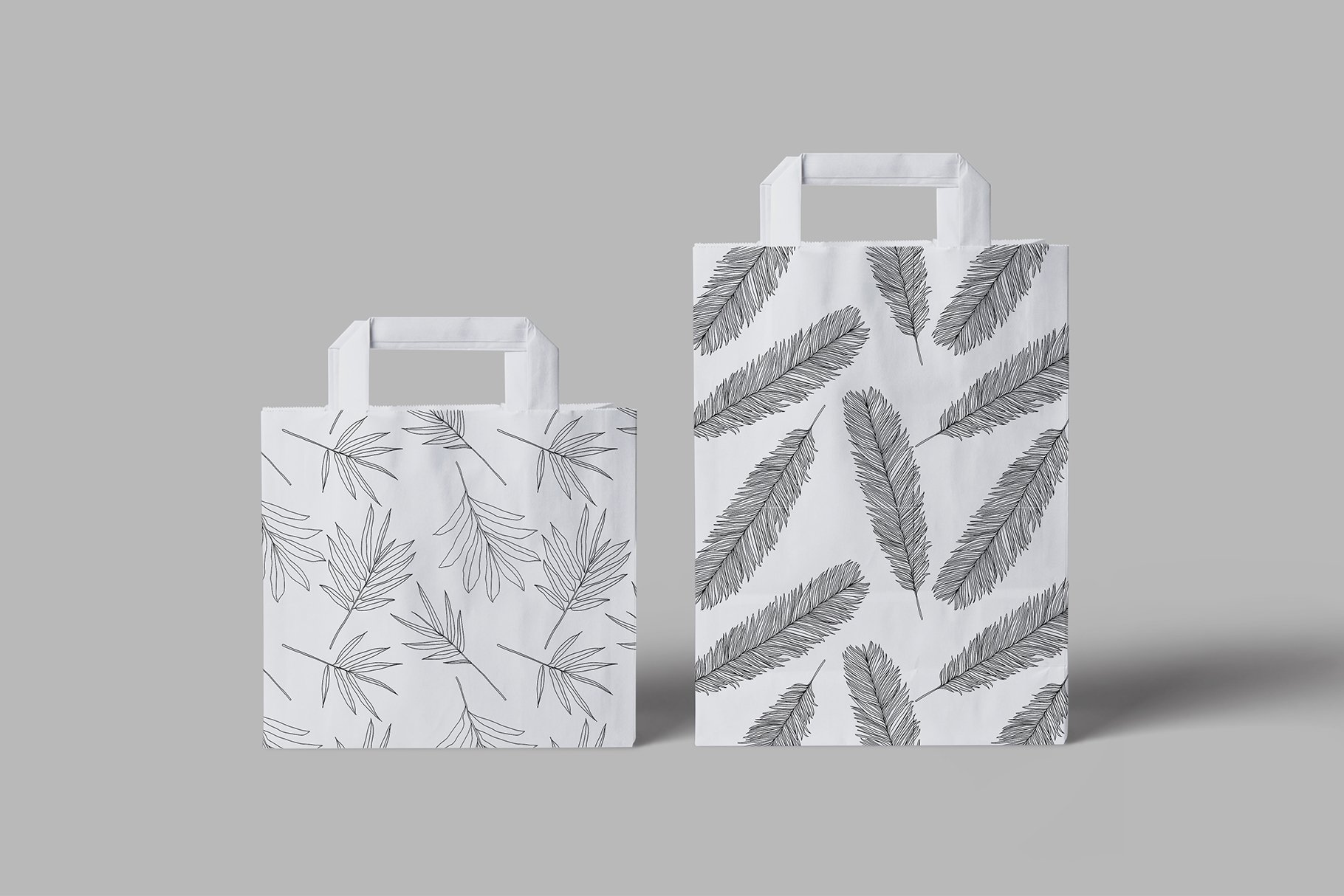 Two bags with a pattern of leaves on them.