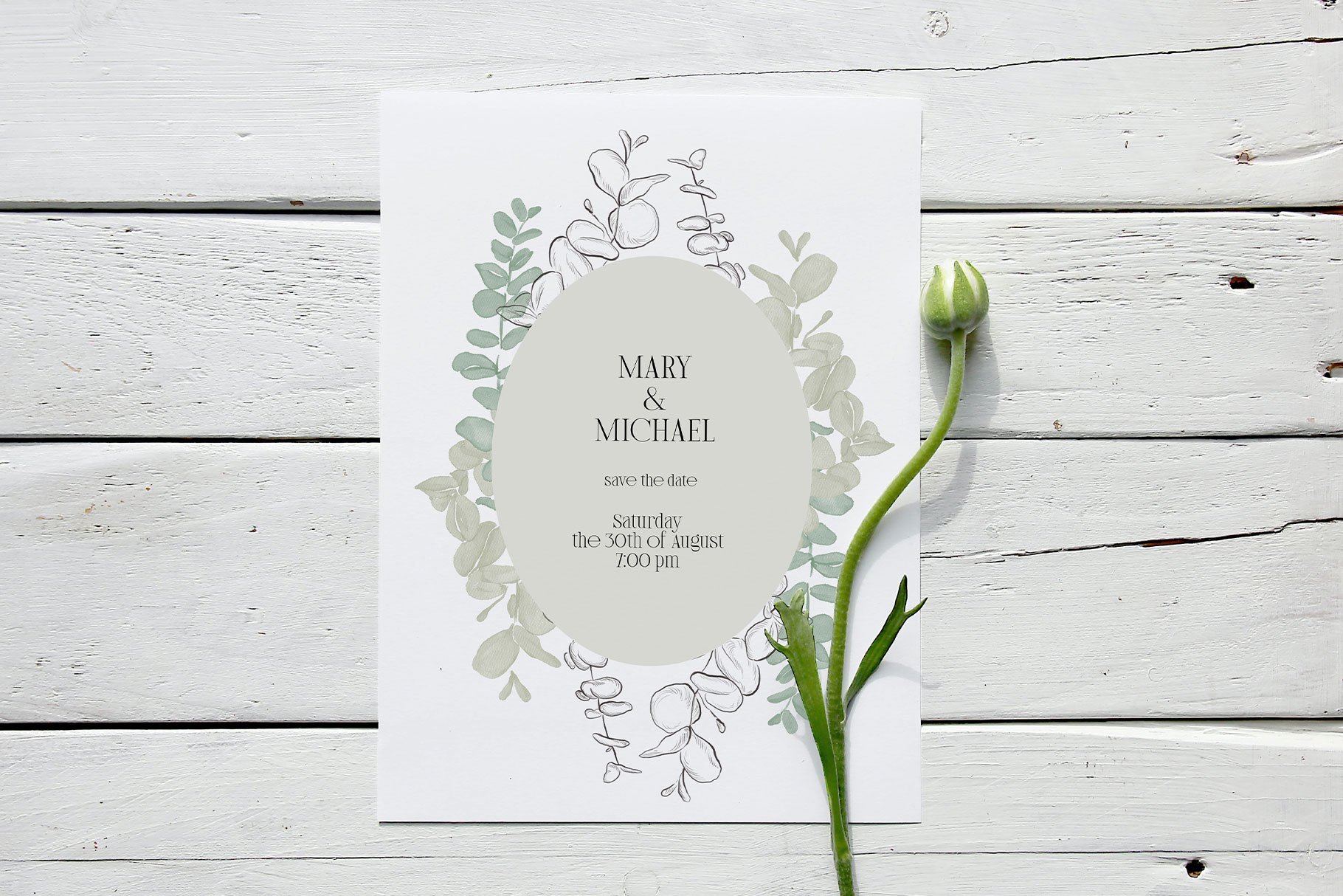 Wedding card with a flower on top of it.