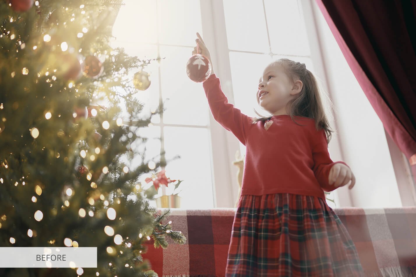 child with baubles near tree at home u8a5876 269
