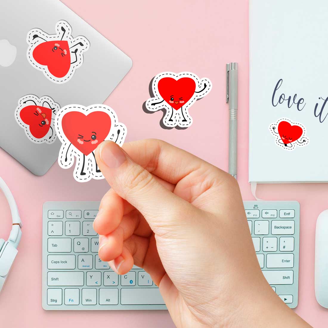 Person holding a sticker over a keyboard.