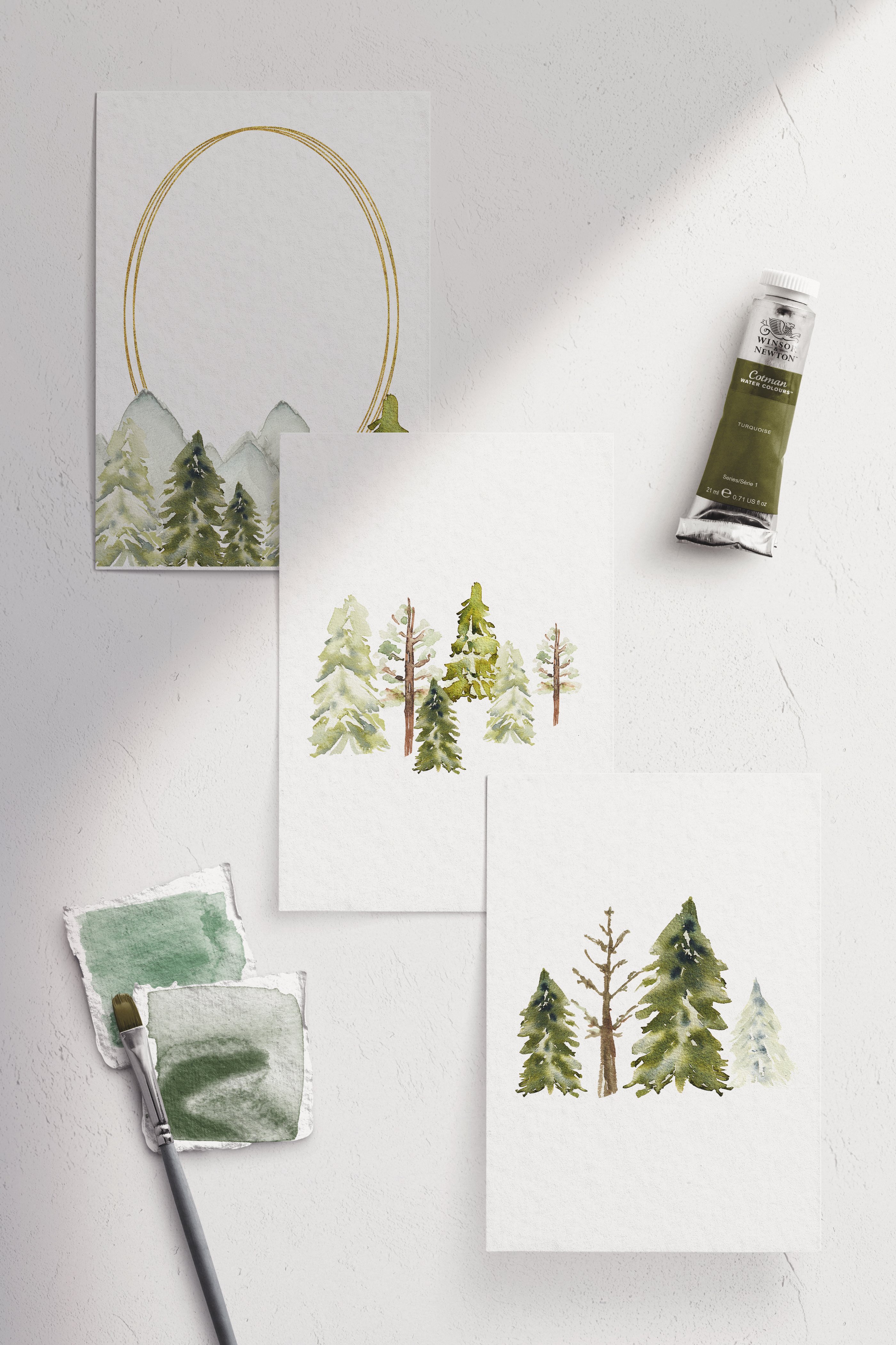 Four watercolor paintings of trees on a white wall.