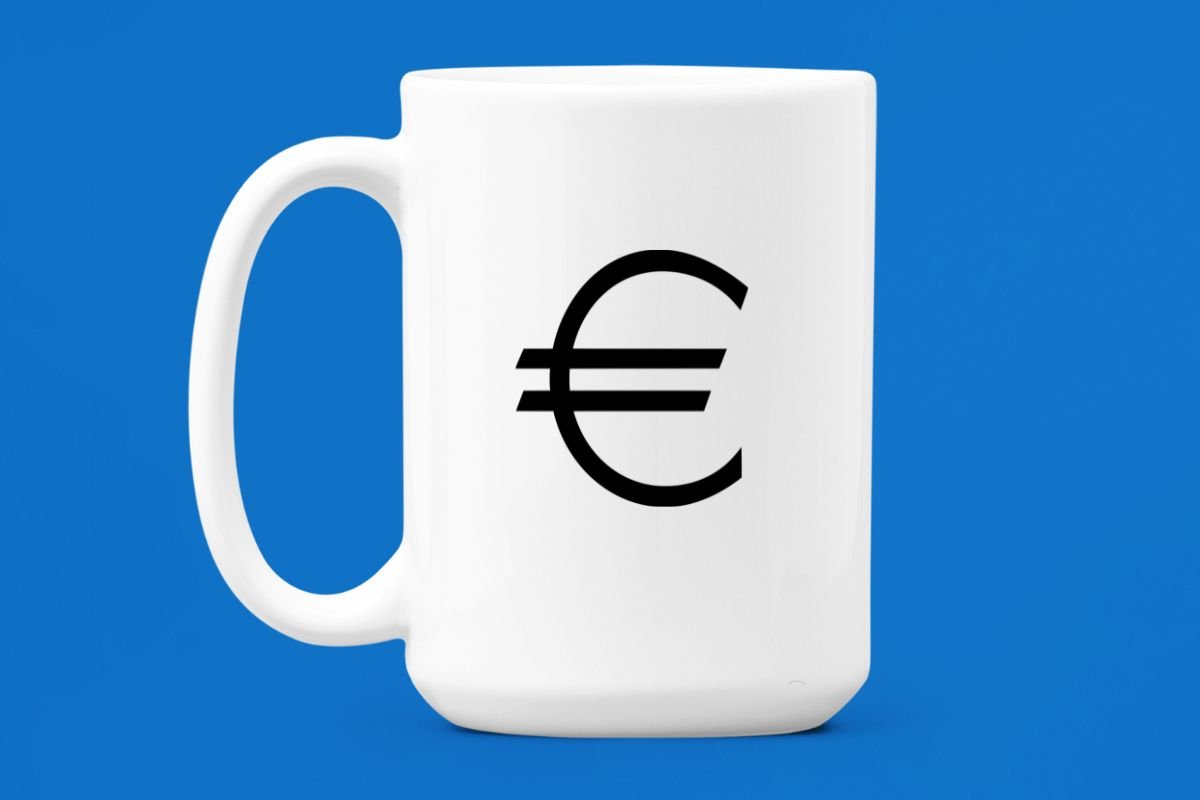 A white coffee mug with a black euro sign on it.