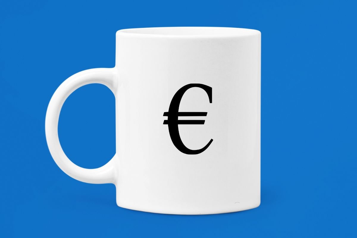 A white coffee mug with the letter e on it.