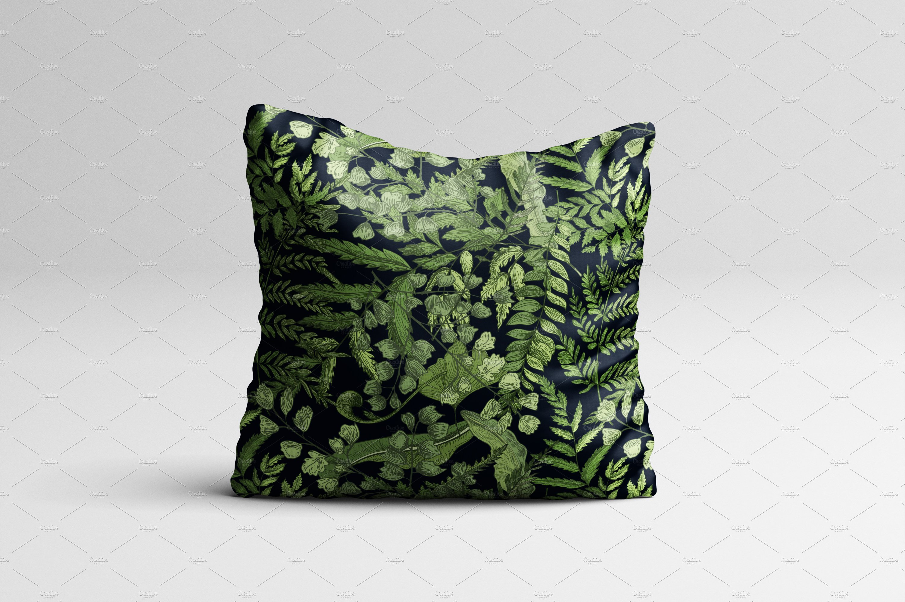 Green and black pillow on a white background.