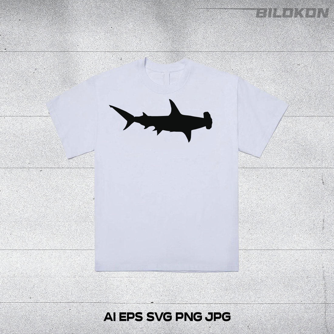 White t - shirt with a black shark on it.