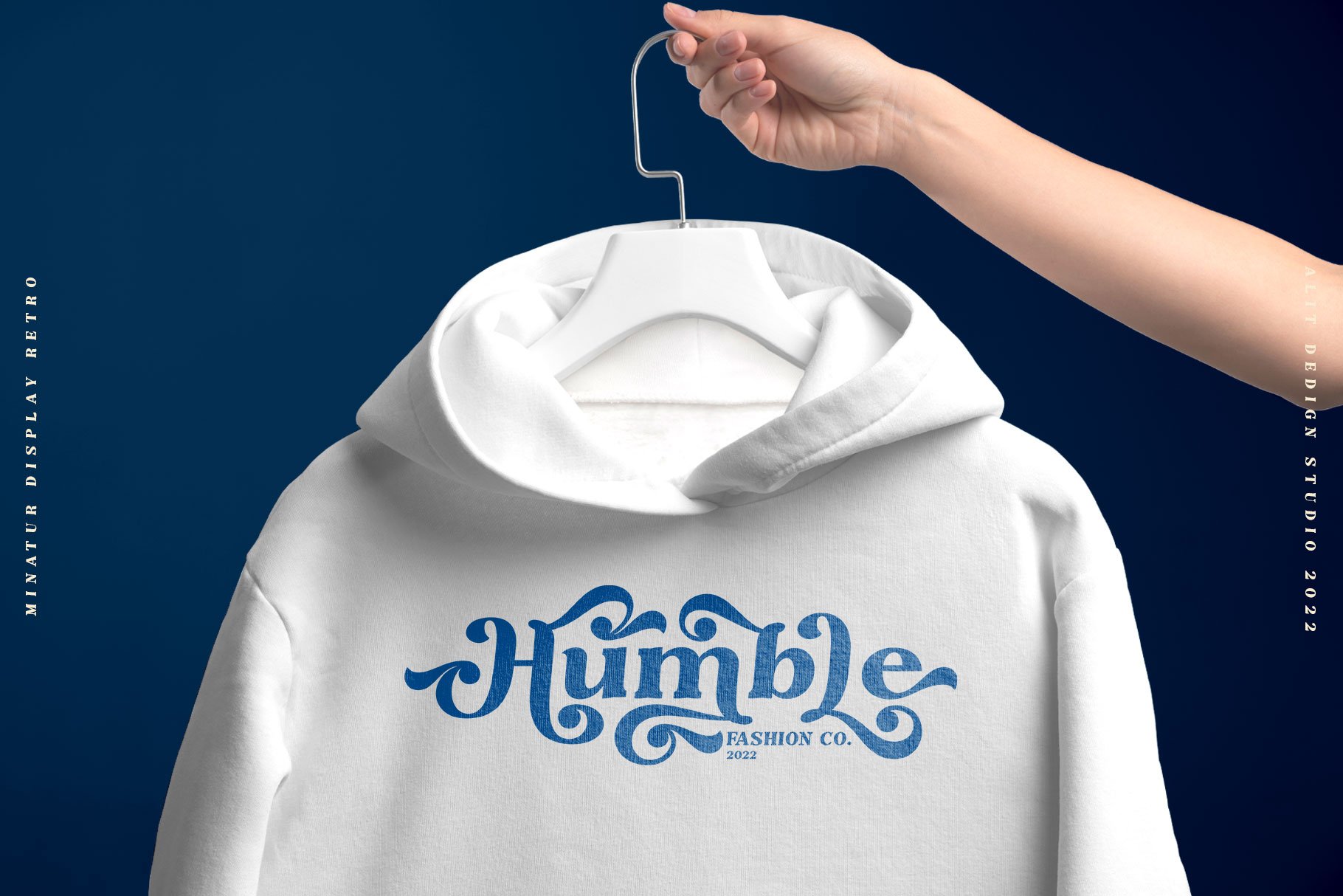 A person holding a white hoodie with the word humble on it.