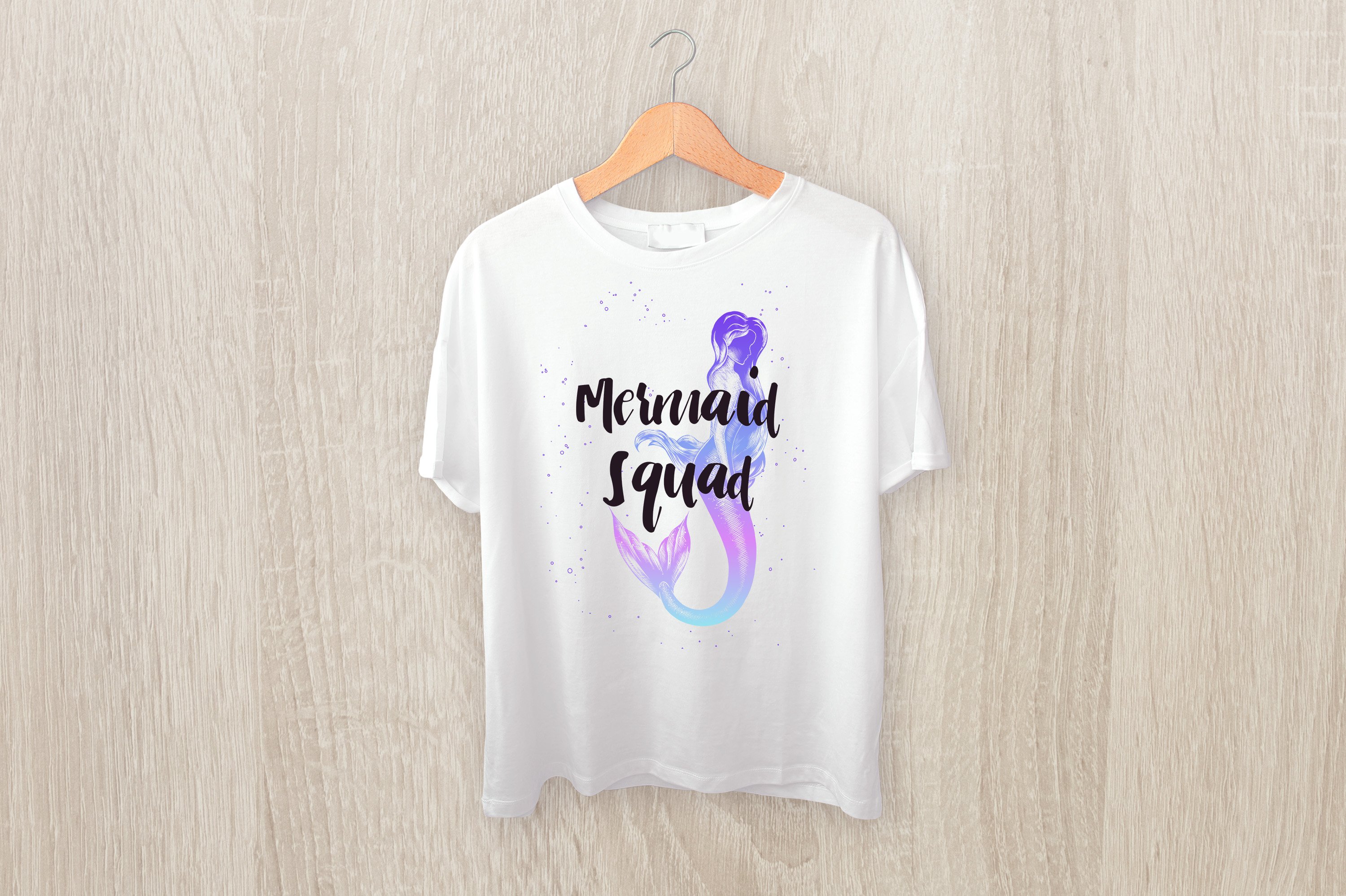White t - shirt with the words mermaid squad on it.