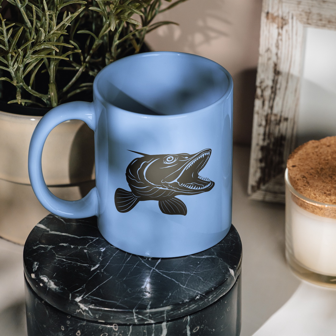 Blue coffee mug with a fish on it.
