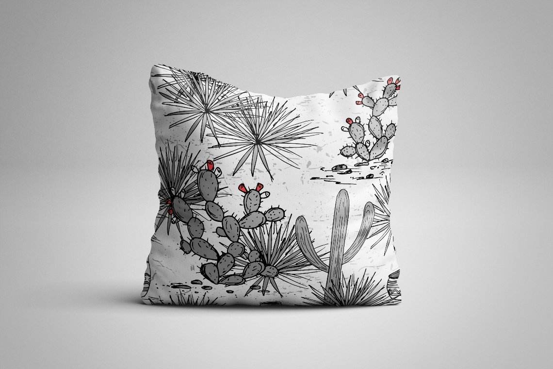 Pillow with a cactus pattern on it.