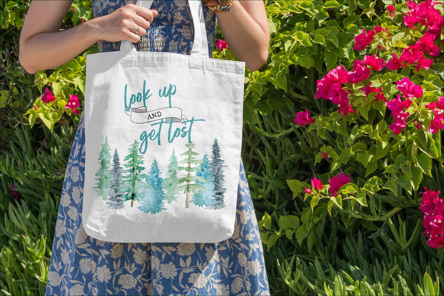 Woman holding a white bag with trees on it.