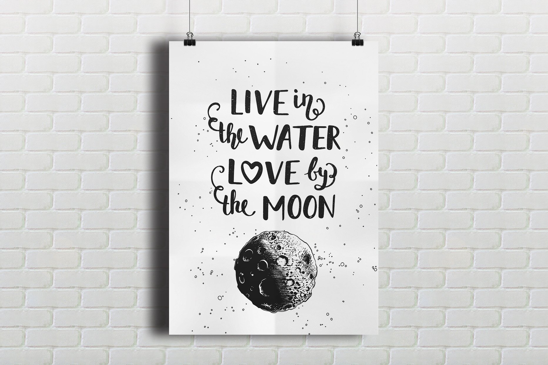 Poster hanging on a brick wall with the words live in the water love by.