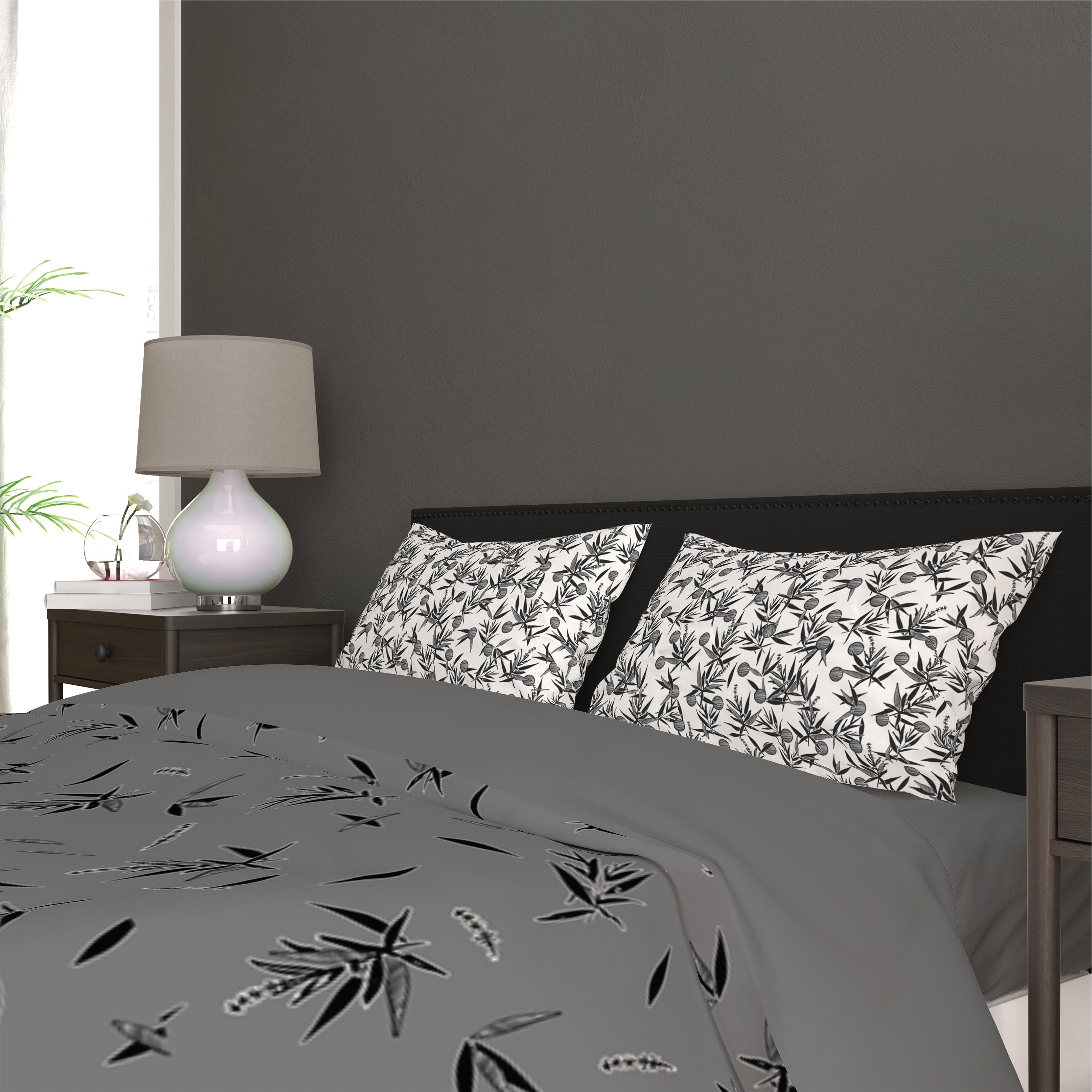 Bed with a gray and white comforter and pillows.