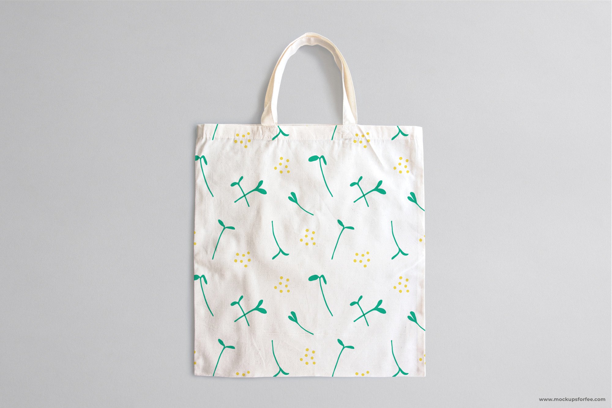 White shopping bag with green and yellow flowers on it.
