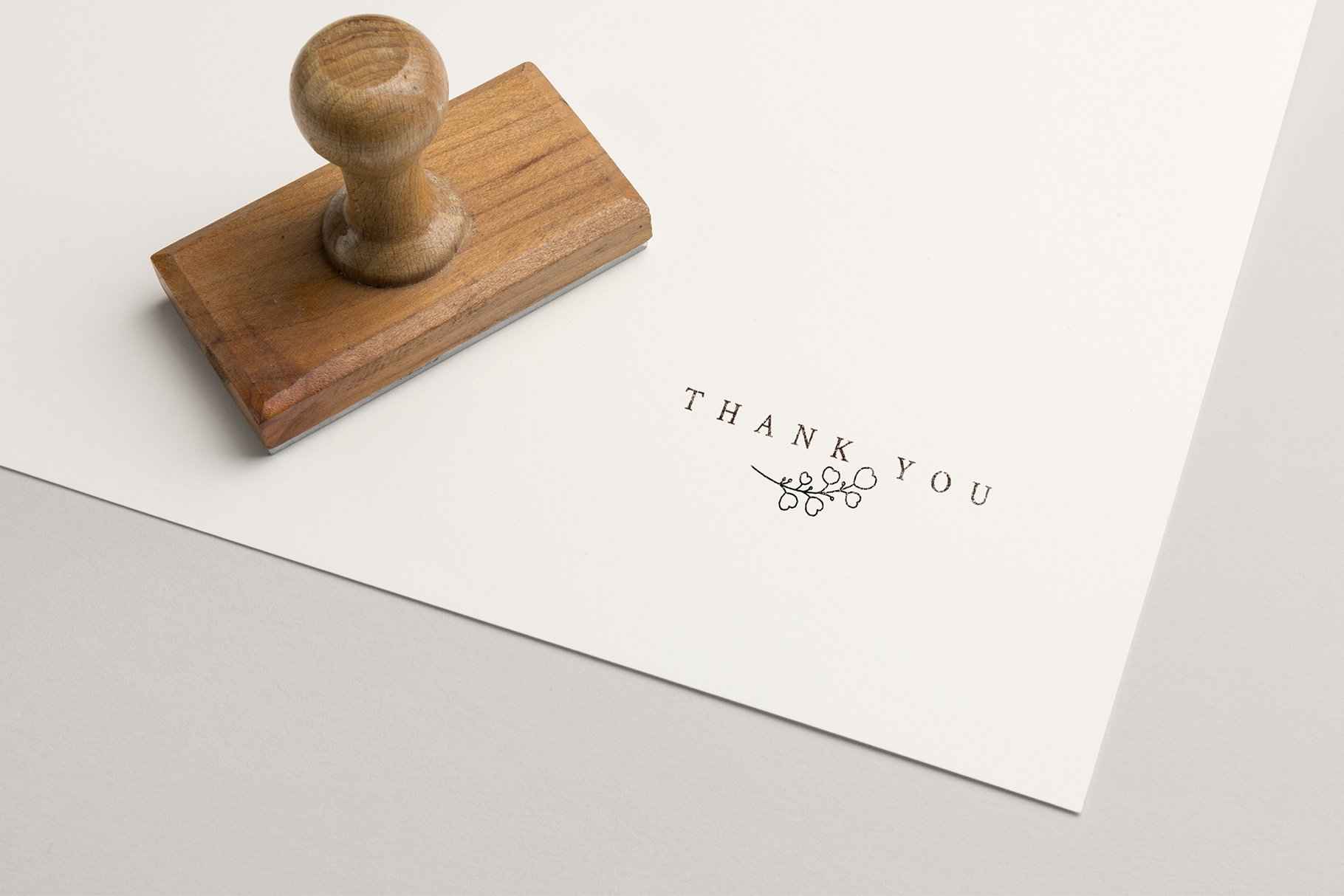 Rubber stamp with the words thank you on it.