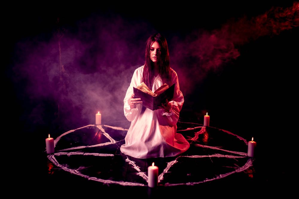 woman sitting in the center of pentagram circle peaw8s6 2 191