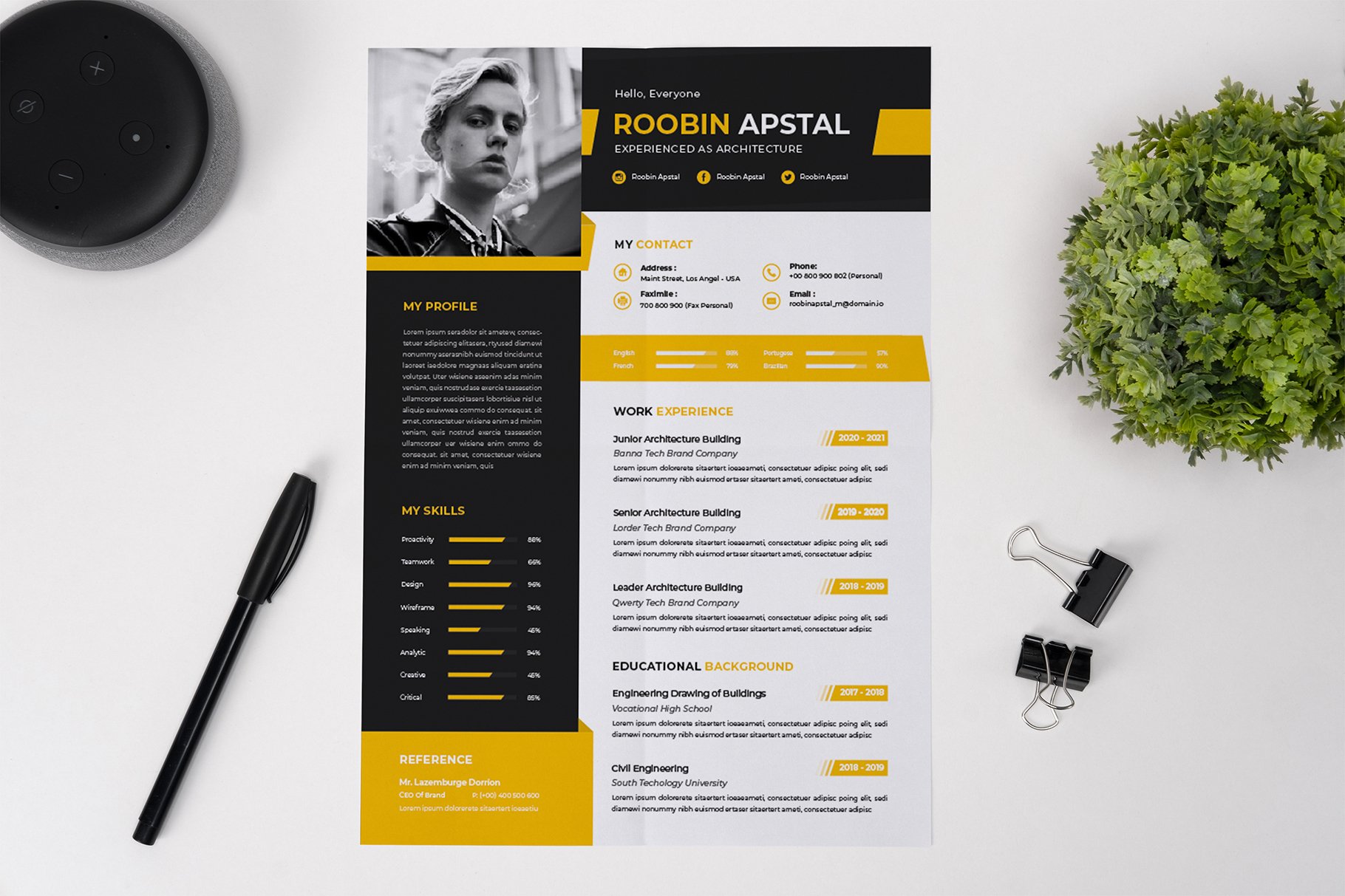 Yellow and black resume sitting on top of a table.