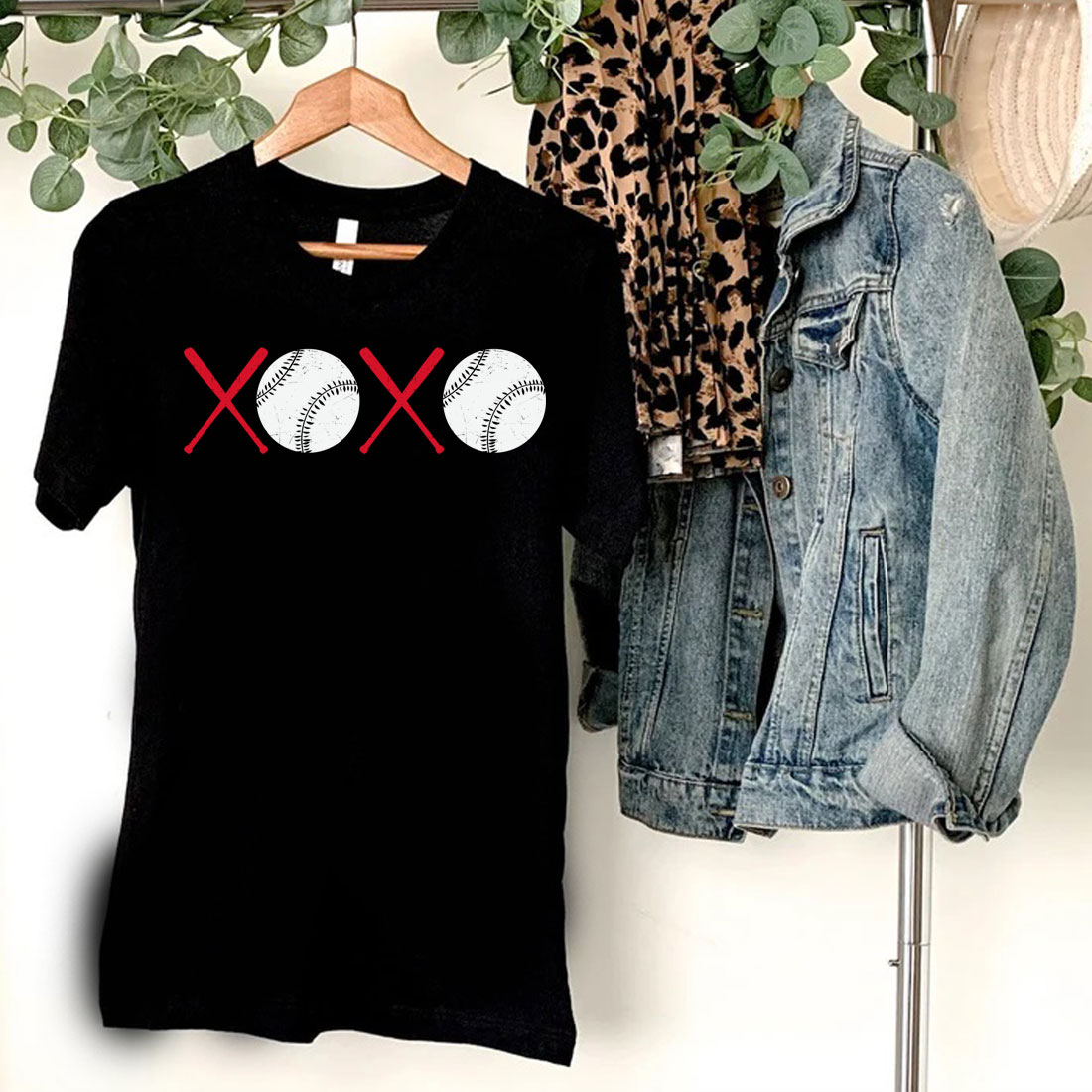 T - shirt with two baseballs and crossed bats on it.