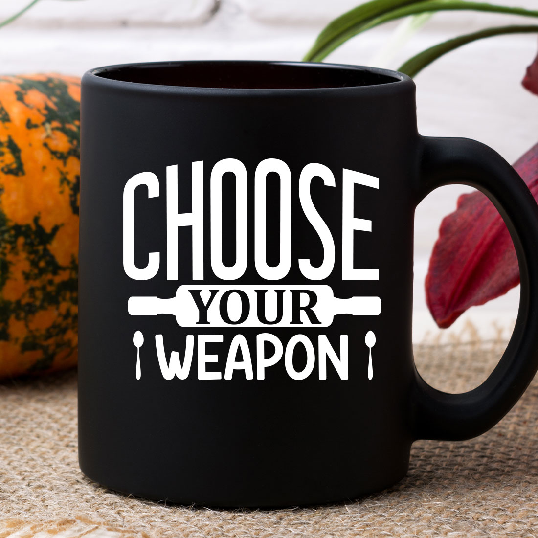 Black coffee mug that says choose your weapon.