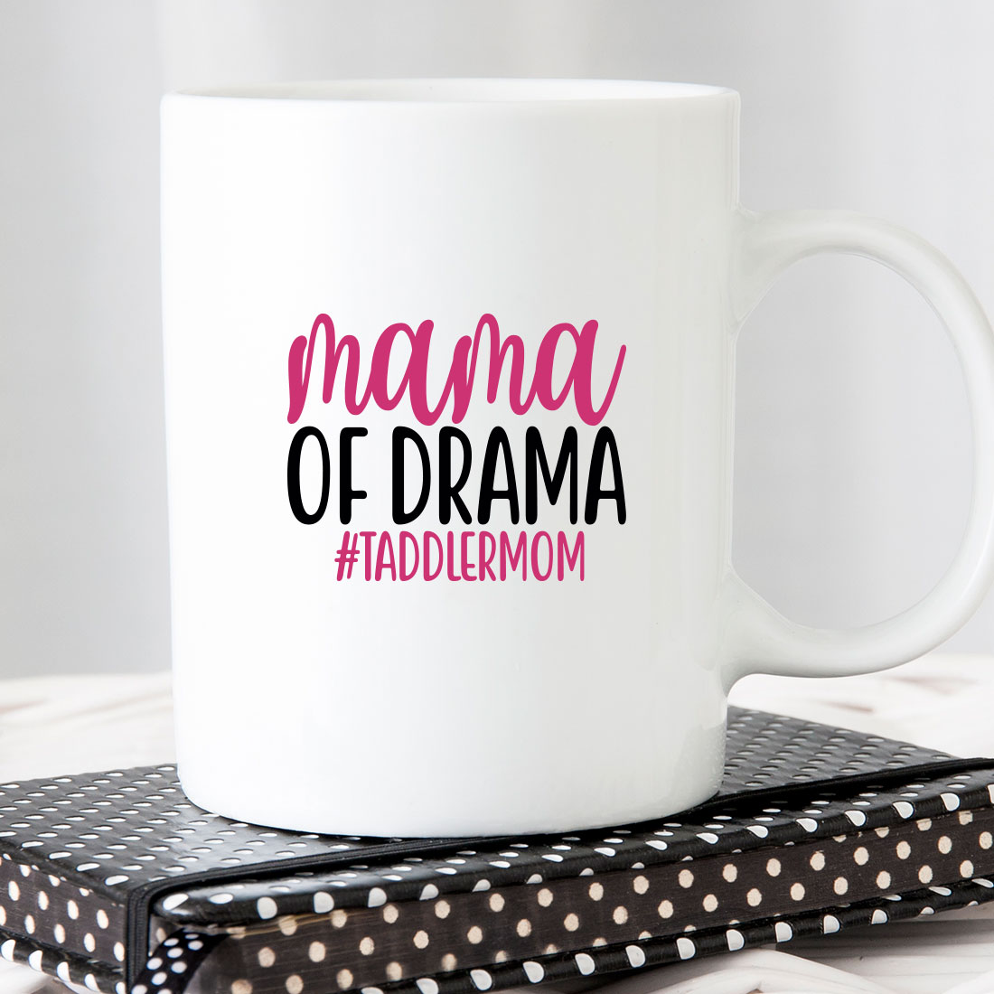 White coffee mug with the words mama of drama on it.