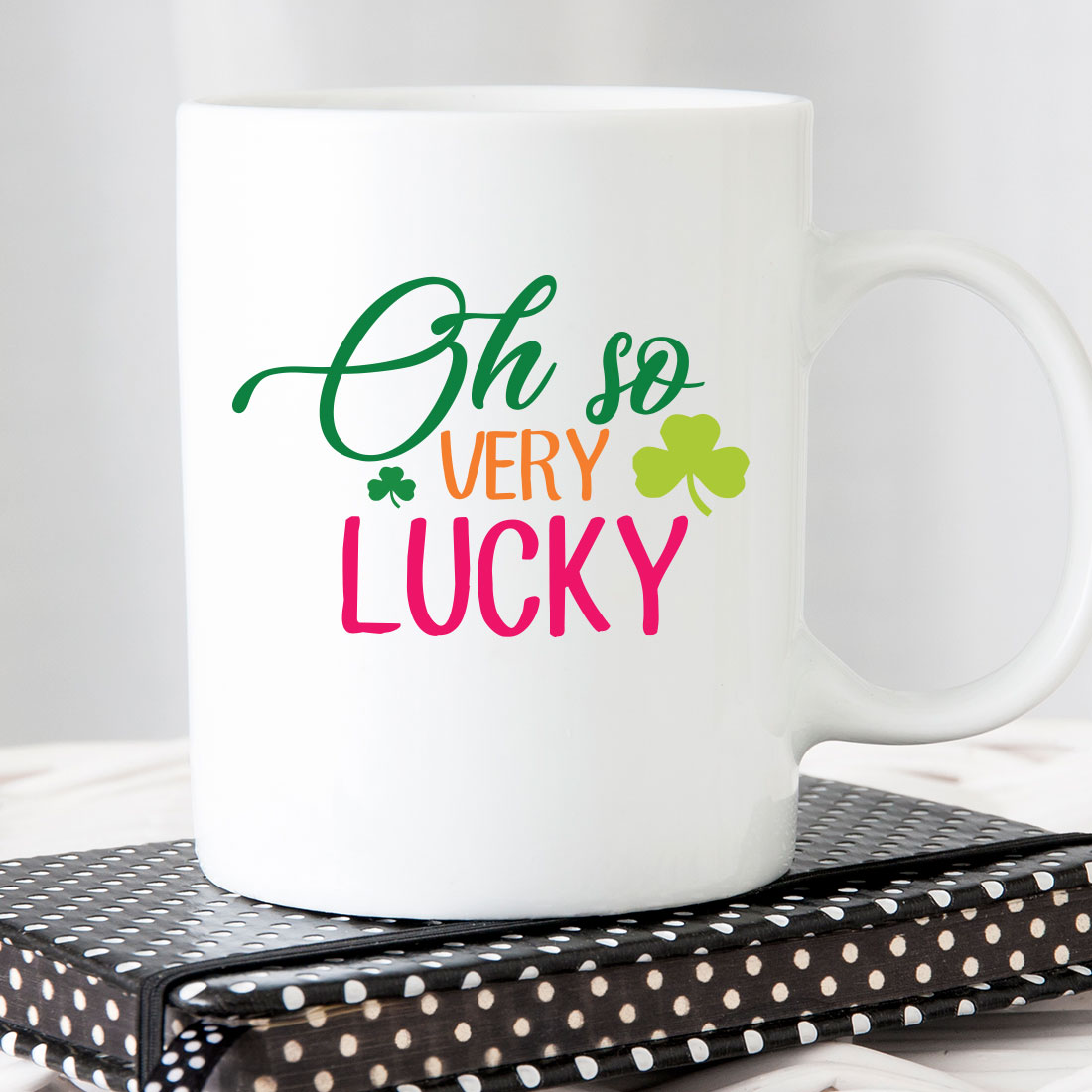 White coffee mug with the words oh so very lucky on it.