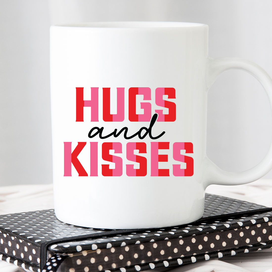 White coffee mug with the words hugs and kisses on it.