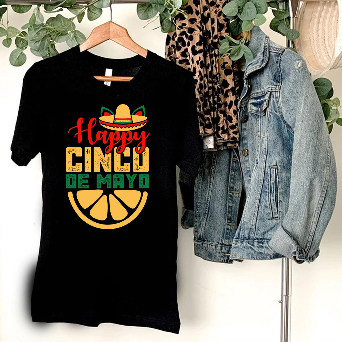 T - shirt that says happy cinco de mayo next to a jean jacket.