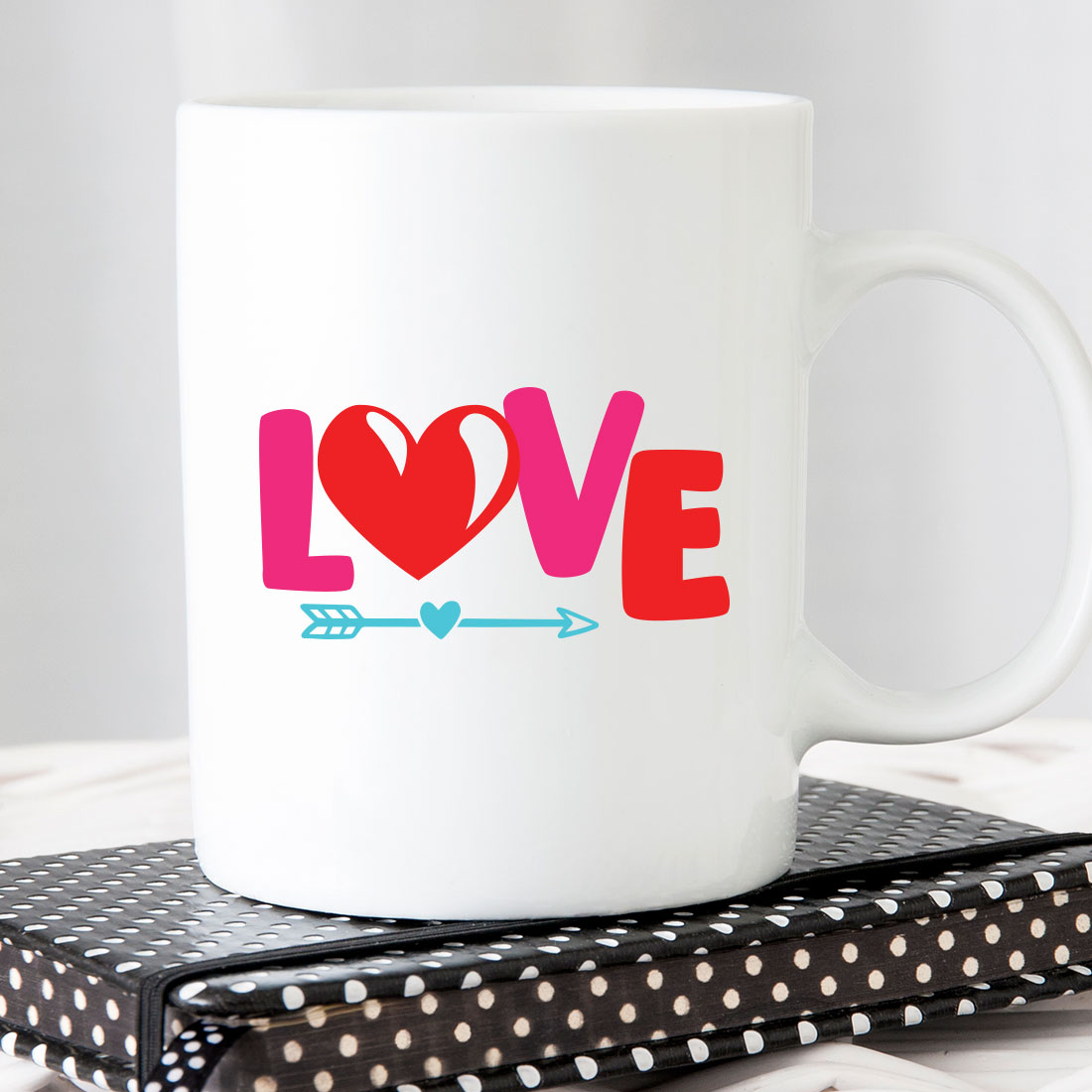 White coffee mug with the word love on it.