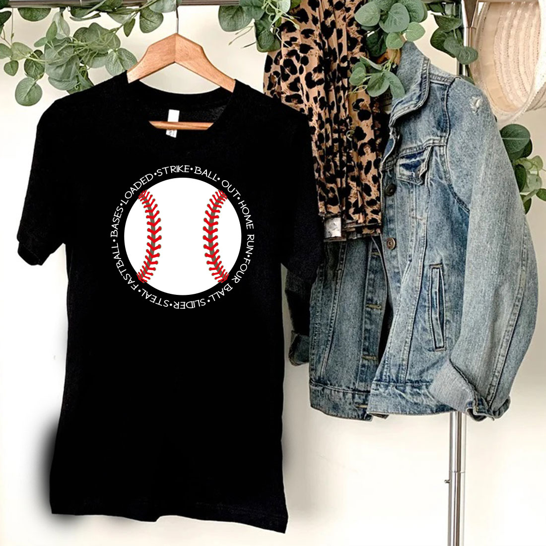 Black shirt with a baseball on it and a leopard print scarf hanging on a.