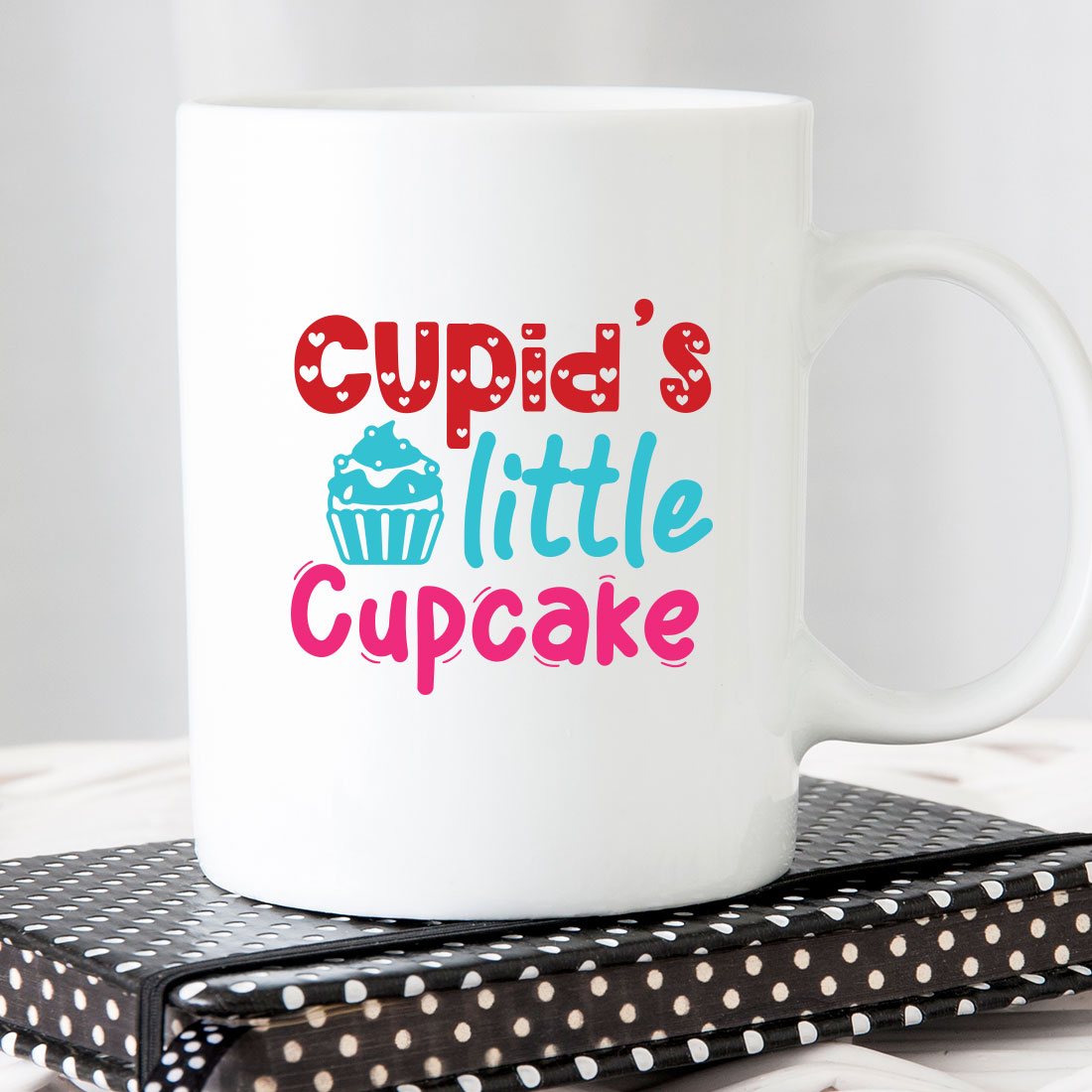 White coffee mug that says cupid's little cupcake.