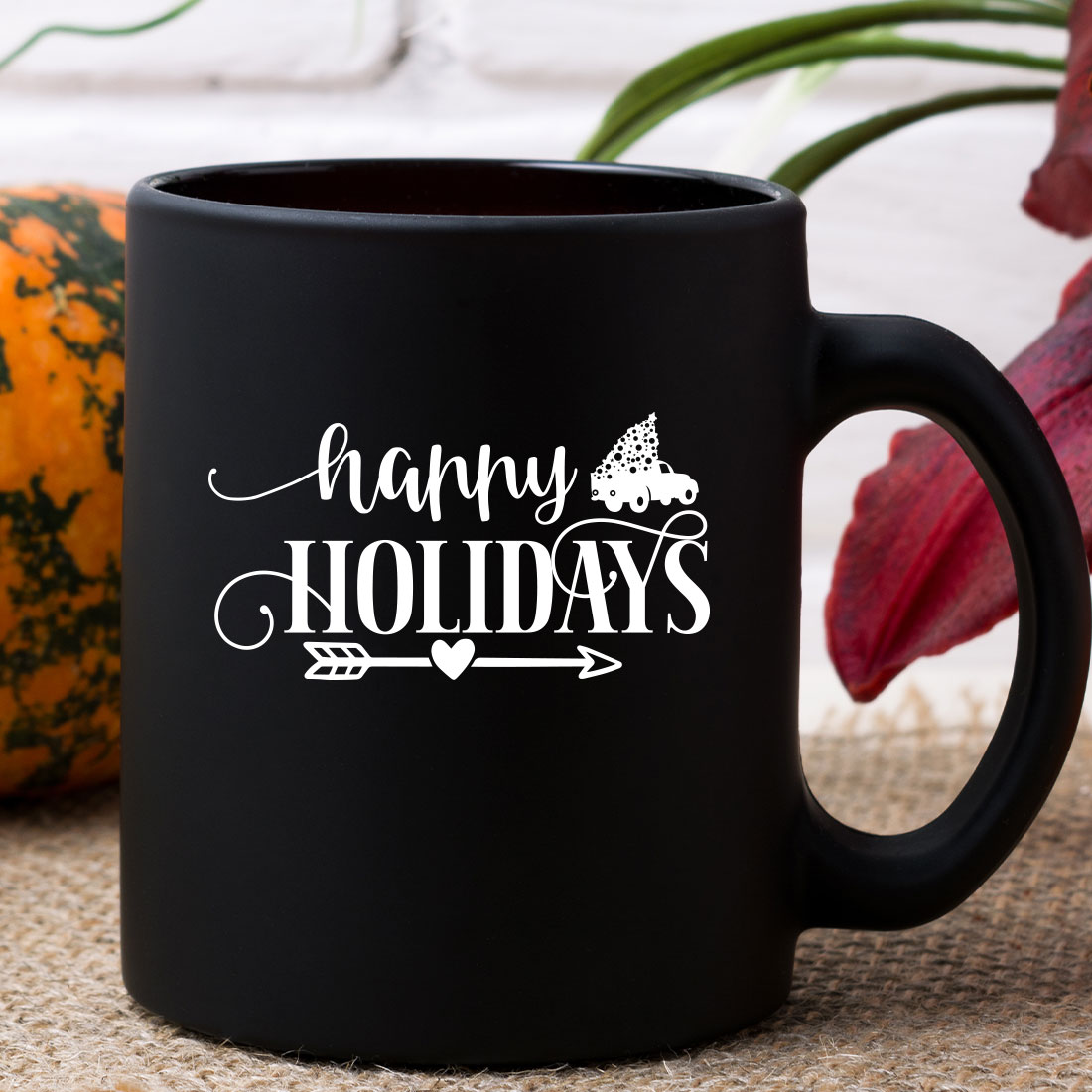 Black coffee mug sitting on top of a table.