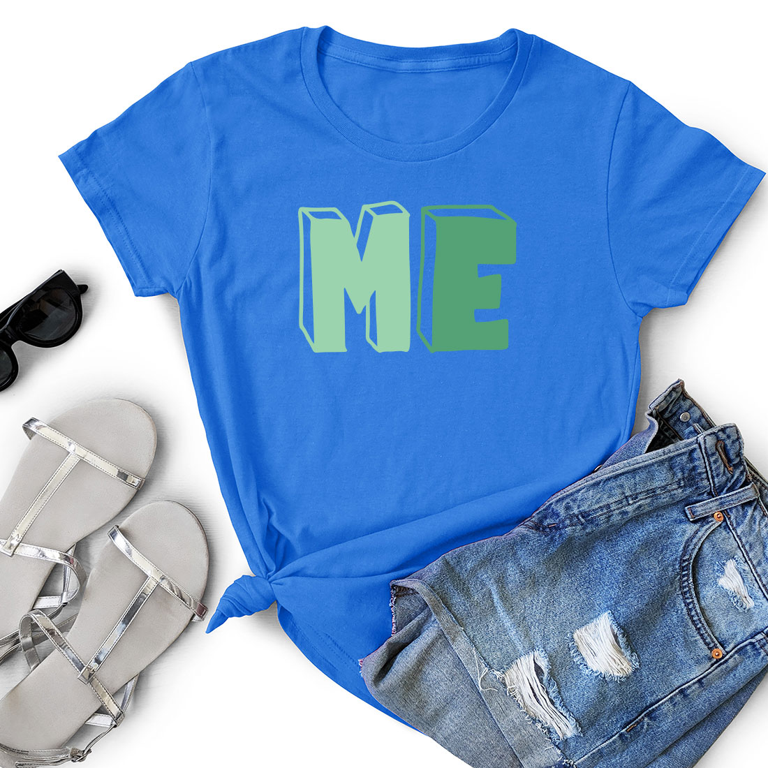 Blue t - shirt with the word me on it next to a pair of.