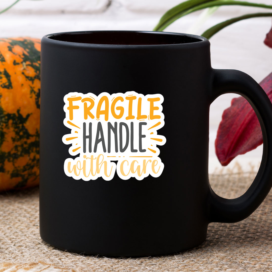 Black coffee mug with the words fragile handle with care on it.