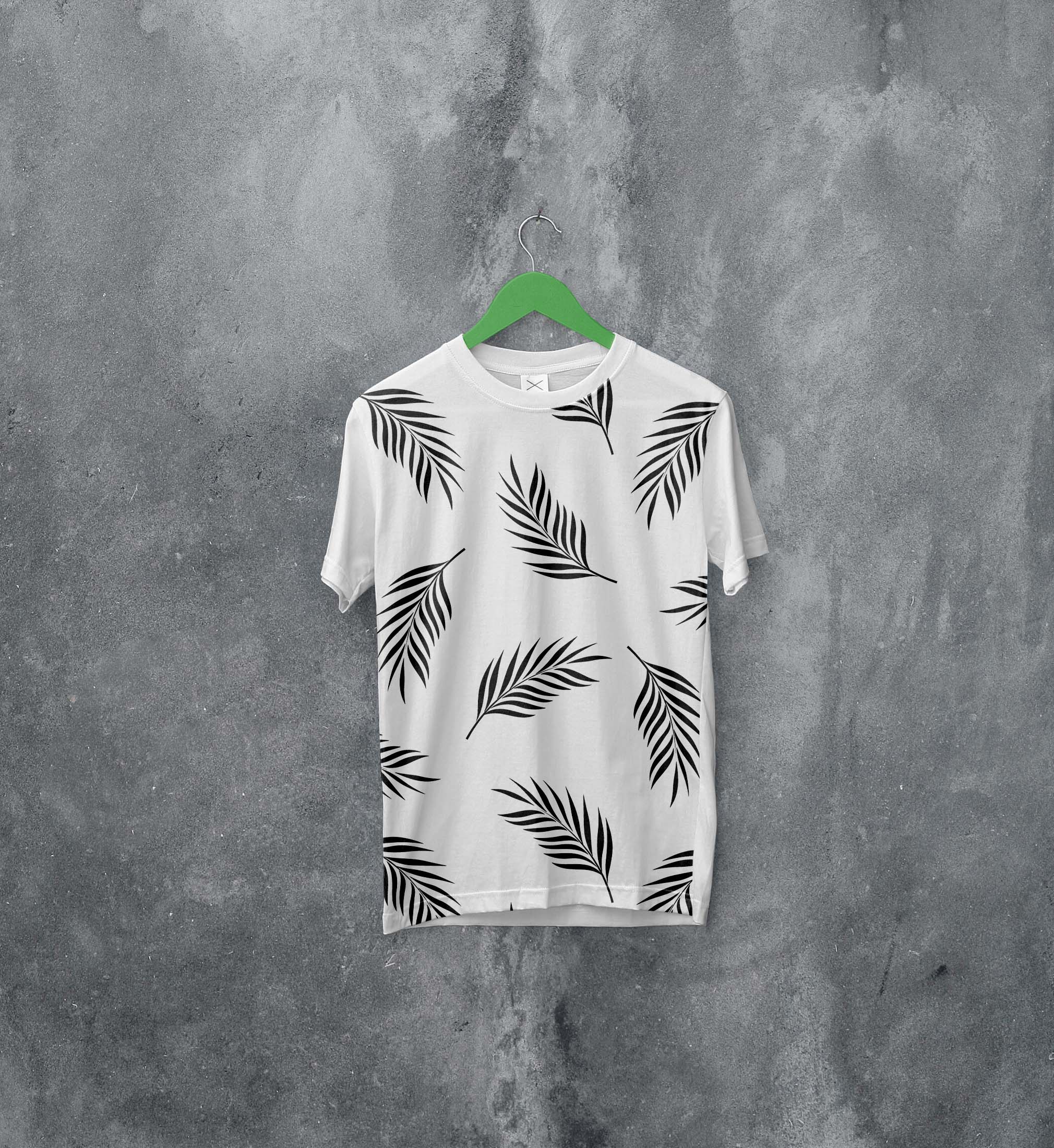 White t - shirt with black leaves on it.