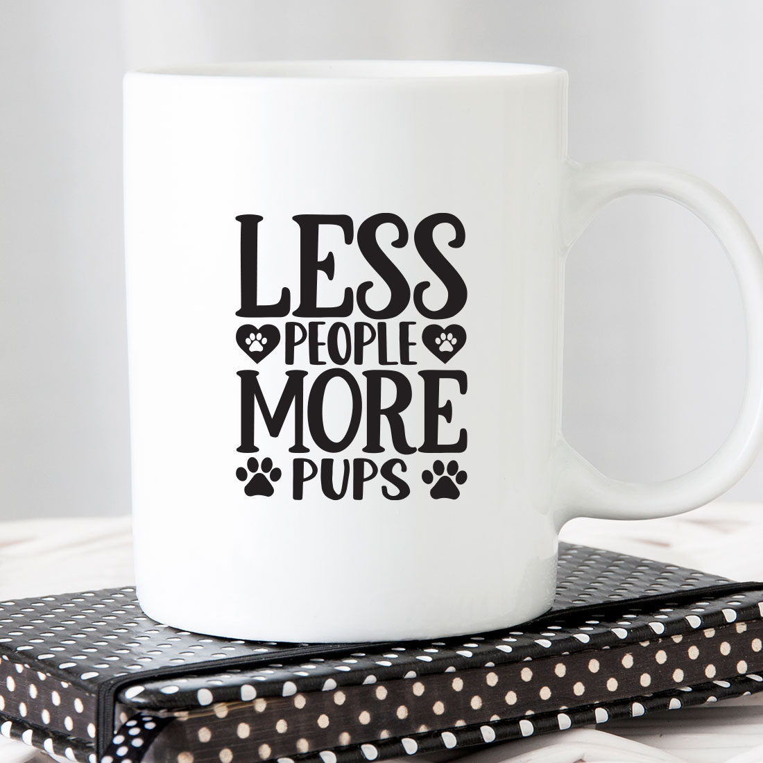 White coffee mug that says less people more pups.