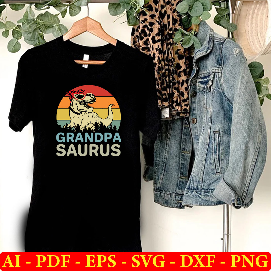 T - shirt that says grandpa saurus next to a pair of jeans.