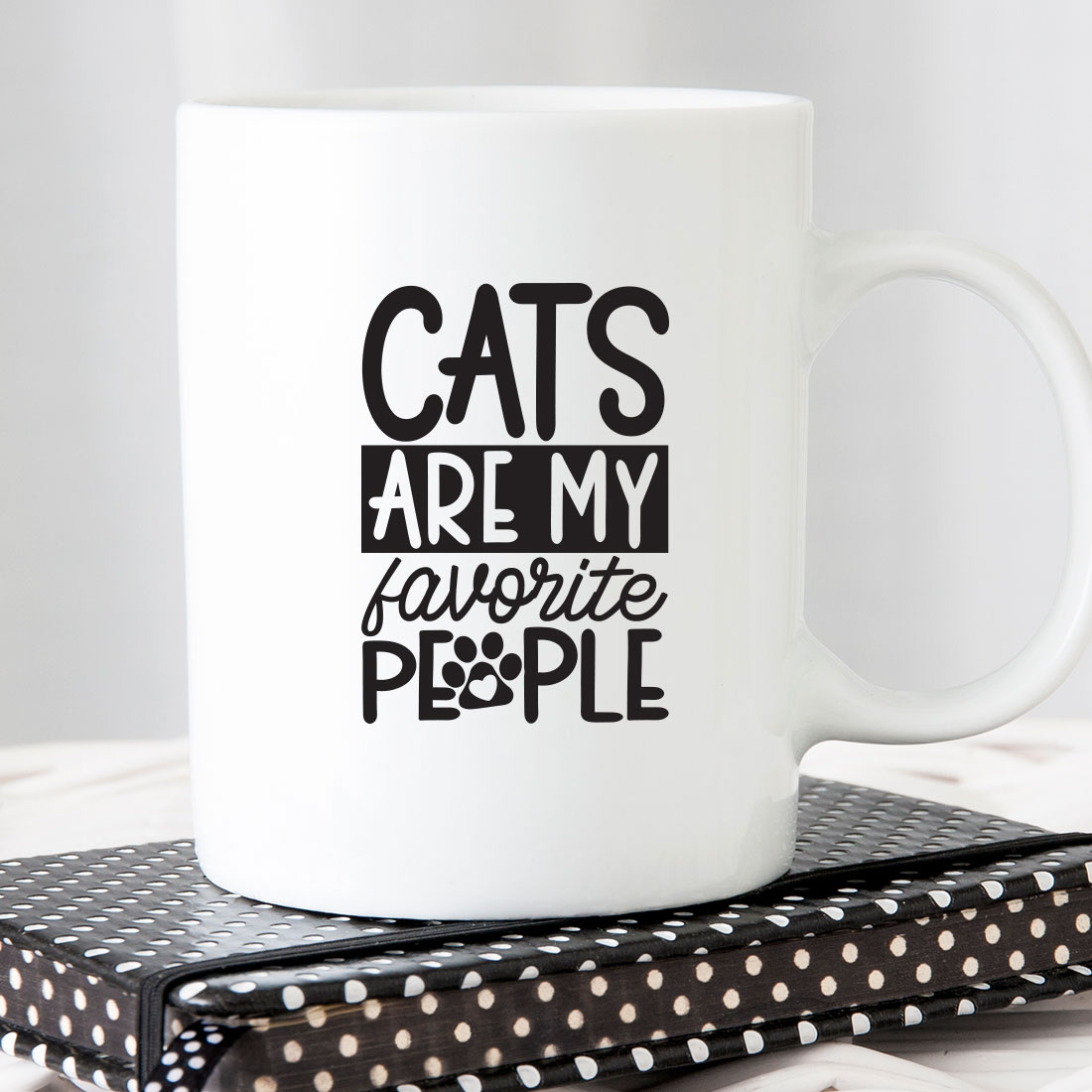 White coffee mug that says cats are my favorite people.