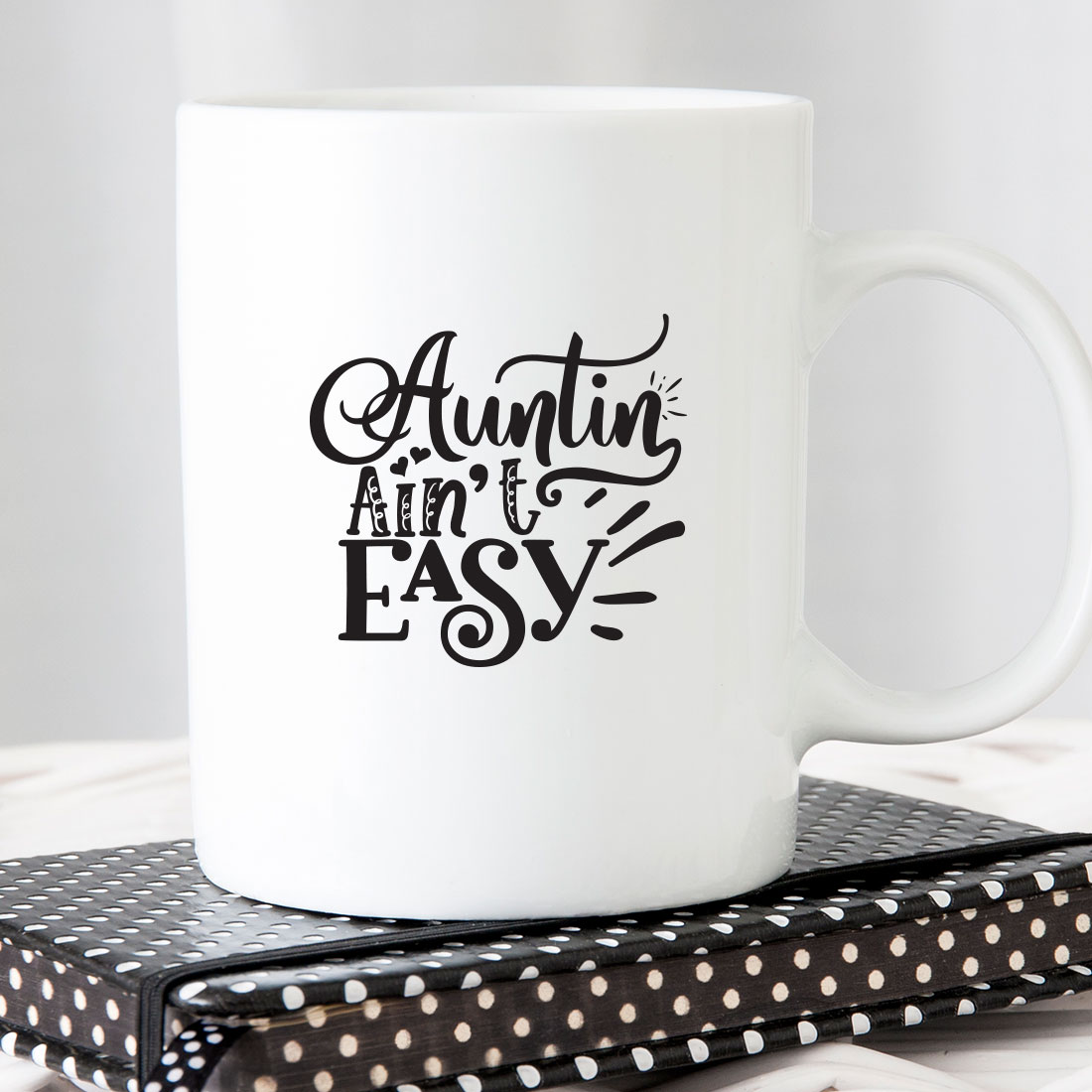 White coffee mug sitting on top of a book.