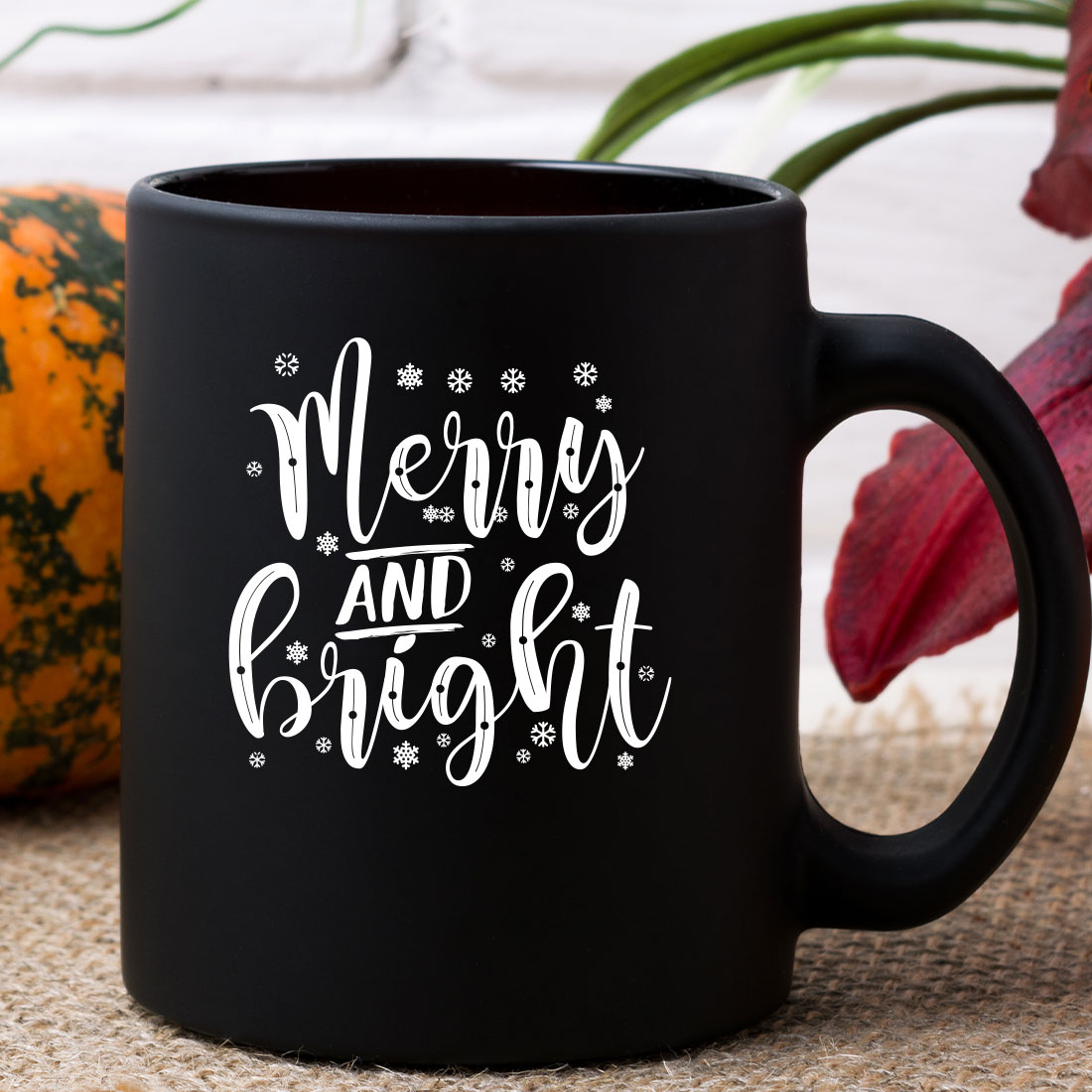 Black coffee mug sitting on top of a table.