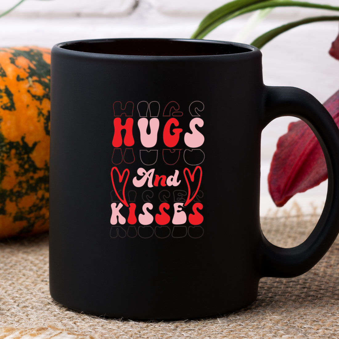 Black coffee mug with hugs and kisses on it.